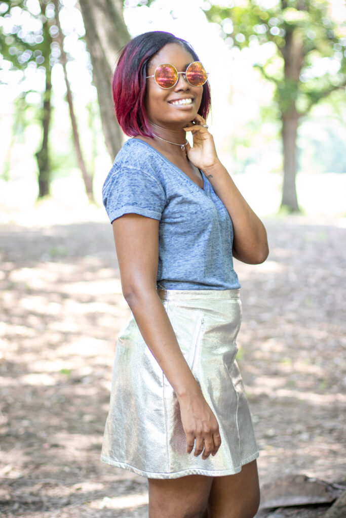 young woman wearing metallic skirt with v-neck